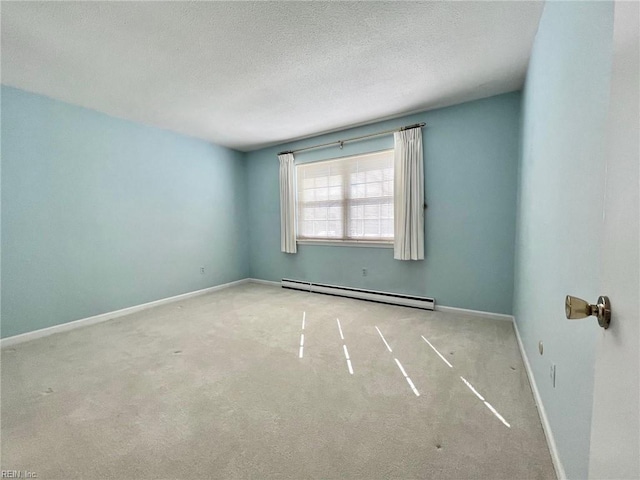 carpeted empty room featuring a baseboard radiator, baseboards, and a textured ceiling