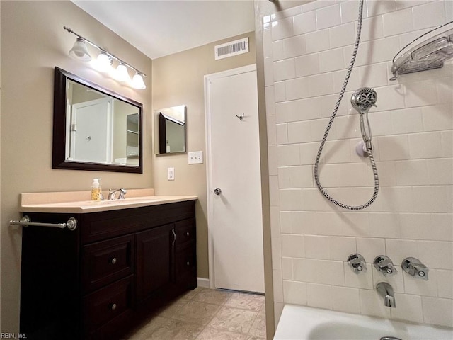 bathroom with vanity, visible vents, and shower / bath combination