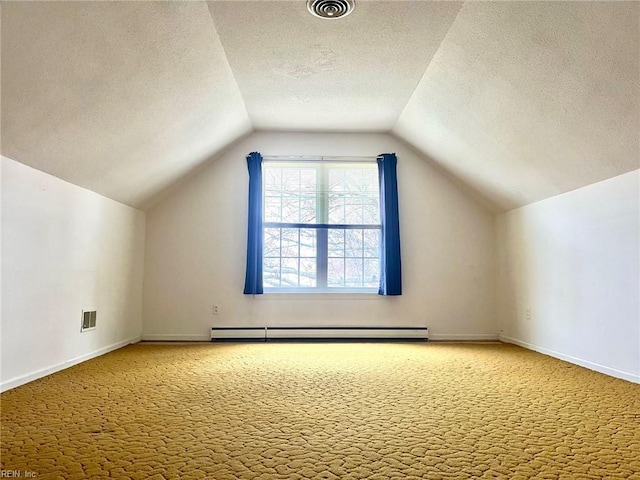 bonus room featuring carpet, visible vents, baseboards, vaulted ceiling, and a baseboard heating unit