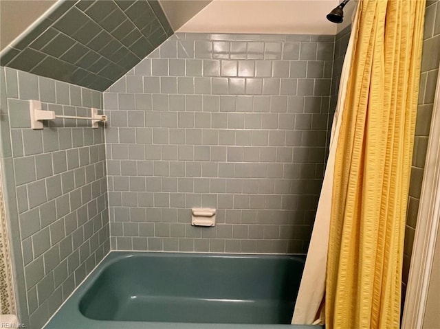 full bathroom featuring shower / tub combo with curtain and lofted ceiling