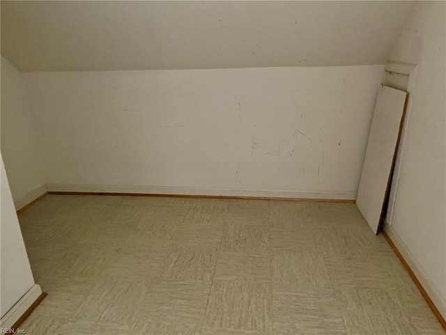 bonus room featuring baseboards and vaulted ceiling