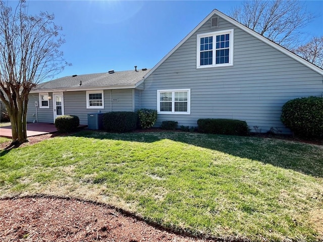 back of property with a patio area, cooling unit, and a yard