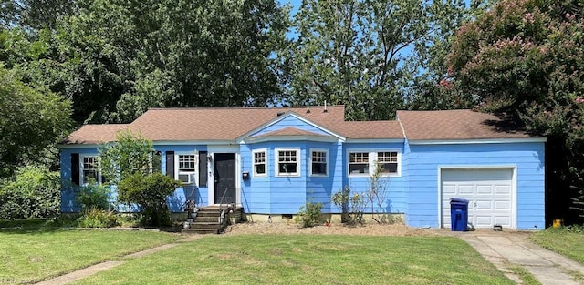 single story home with crawl space, concrete driveway, a front lawn, and a garage