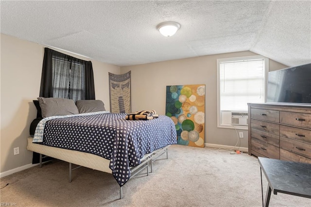 carpeted bedroom featuring cooling unit, lofted ceiling, a textured ceiling, and baseboards