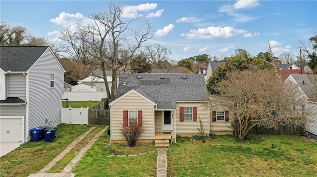 view of front of property featuring a front lawn, a gate, concrete driveway, and fence