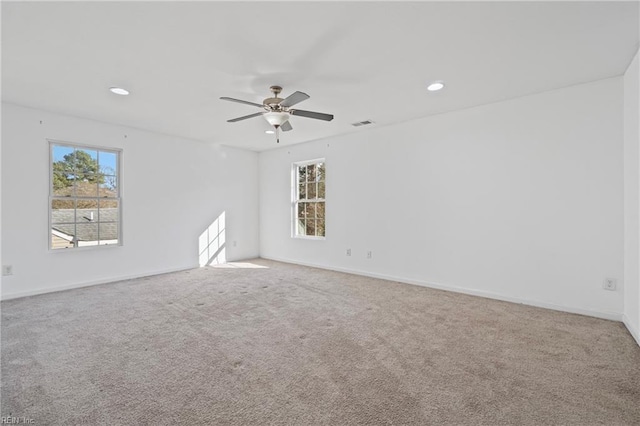 carpeted empty room with a ceiling fan, visible vents, recessed lighting, and baseboards