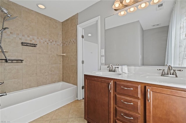 bathroom with tile patterned flooring, visible vents, and a sink