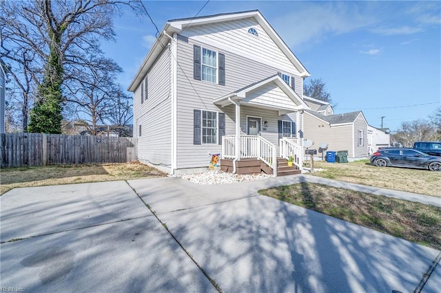 view of front of home featuring a porch and fence