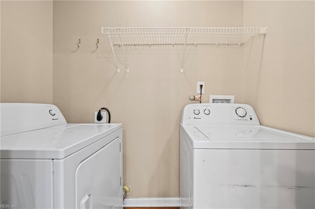 washroom featuring laundry area and washing machine and dryer