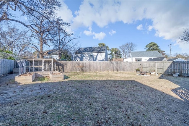 view of yard with a garden and a fenced backyard