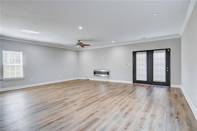 unfurnished living room featuring heating unit, baseboards, light wood-style flooring, recessed lighting, and crown molding