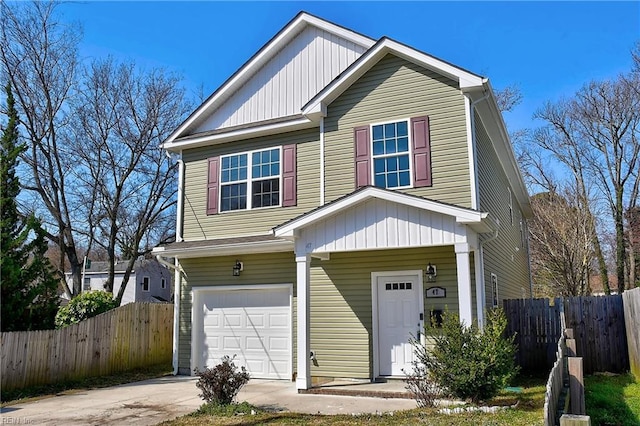 view of front of home with an attached garage, fence, and driveway