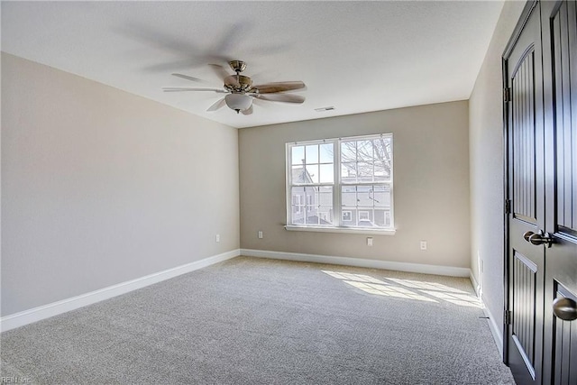 unfurnished room featuring visible vents, baseboards, light carpet, and ceiling fan