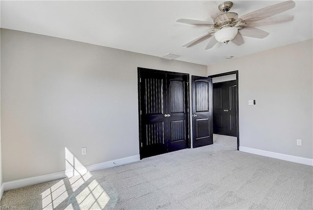 unfurnished bedroom featuring baseboards, carpet floors, and ceiling fan