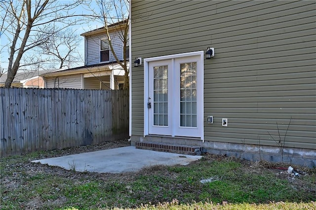 property entrance with a patio and fence