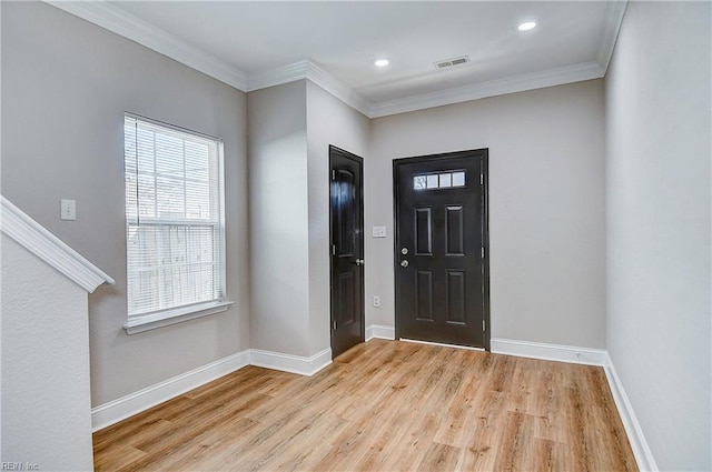 entrance foyer with crown molding, baseboards, and light wood-type flooring