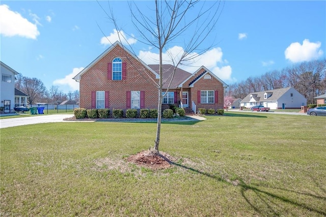 traditional-style house featuring brick siding and a front lawn