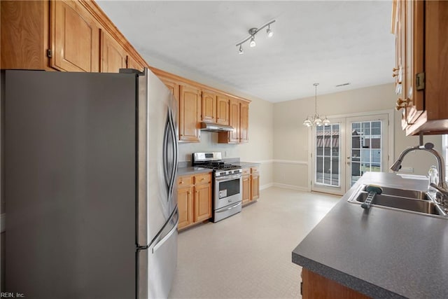 kitchen featuring baseboards, a sink, hanging light fixtures, stainless steel appliances, and under cabinet range hood