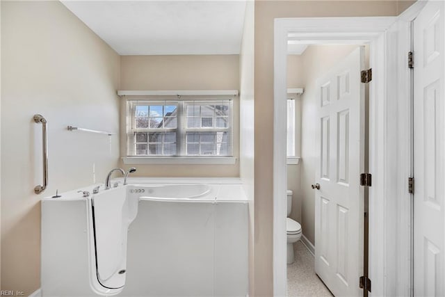 full bath featuring toilet and a bathtub