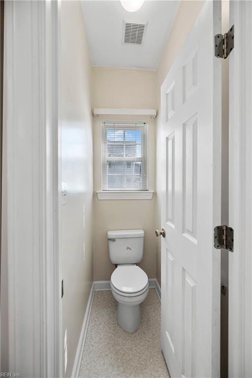 bathroom featuring toilet, baseboards, and visible vents