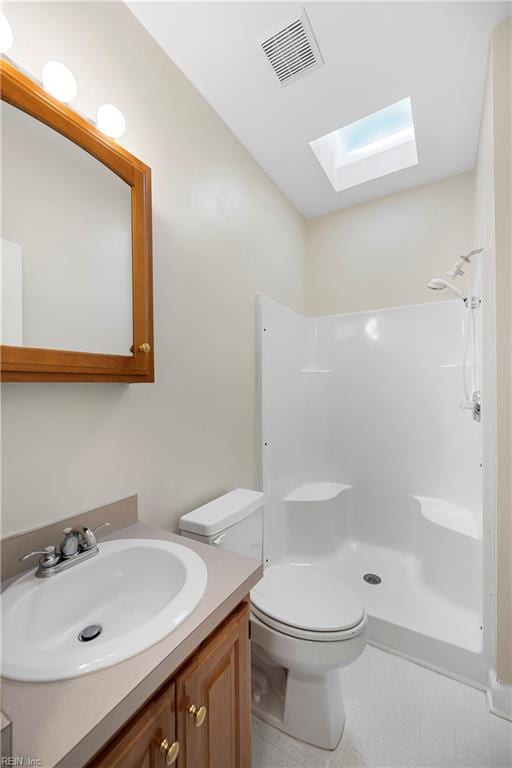 bathroom with visible vents, walk in shower, toilet, a skylight, and vanity