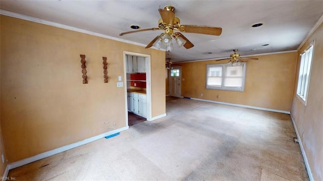 empty room with a ceiling fan, baseboards, and ornamental molding