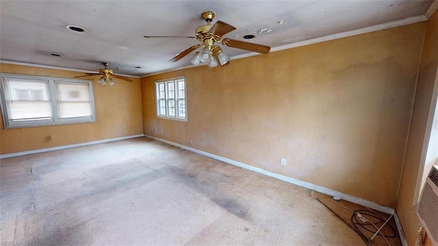 empty room featuring ceiling fan, baseboards, carpet floors, and ornamental molding