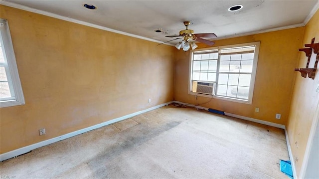 carpeted empty room featuring crown molding, plenty of natural light, baseboards, and ceiling fan