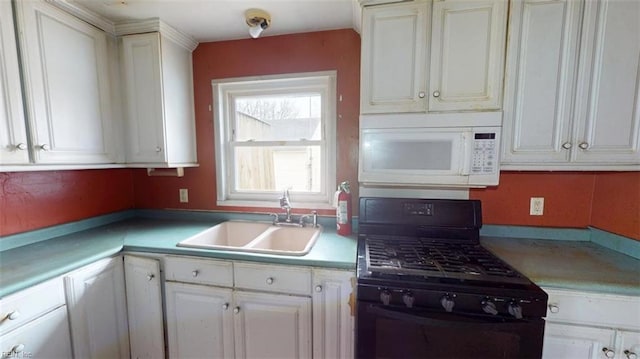 kitchen with a sink, white microwave, black gas range oven, and white cabinetry