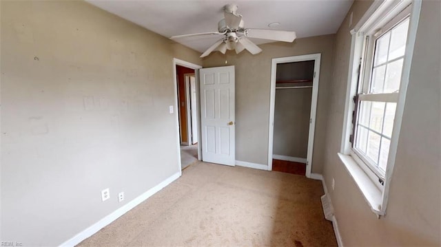 unfurnished bedroom featuring a closet, multiple windows, baseboards, and carpet floors