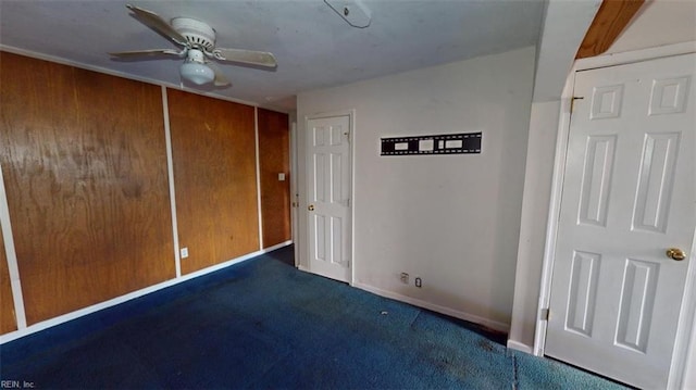 unfurnished room with baseboards, carpet, and ceiling fan