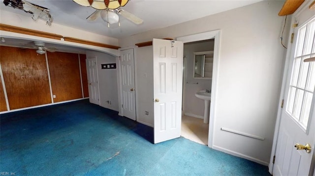 unfurnished bedroom featuring carpet flooring and arched walkways