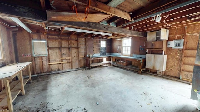 interior space with a workshop area and unfinished concrete flooring