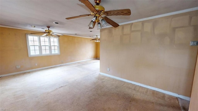 carpeted spare room with crown molding, a ceiling fan, and baseboards