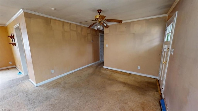 unfurnished room with ceiling fan, baseboards, ornamental molding, and carpet flooring