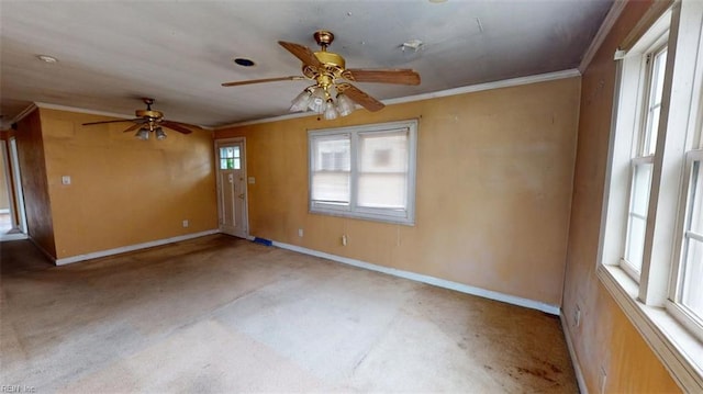 spare room with crown molding, baseboards, and ceiling fan