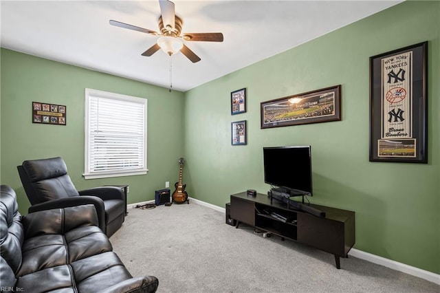 carpeted living room with a ceiling fan and baseboards