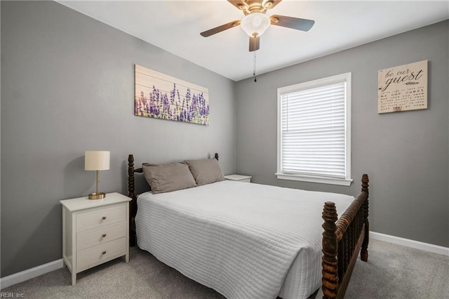 bedroom with light carpet, ceiling fan, and baseboards