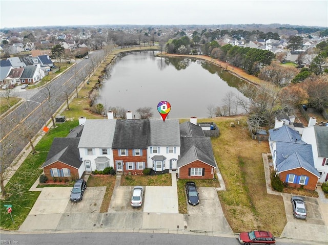 bird's eye view featuring a water view and a residential view