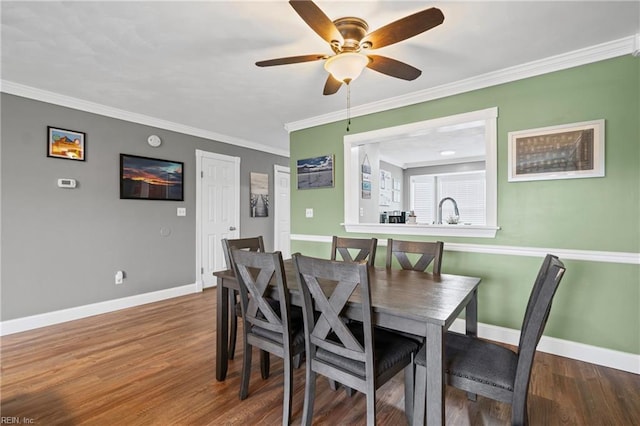 dining area featuring a ceiling fan, crown molding, wood finished floors, and baseboards