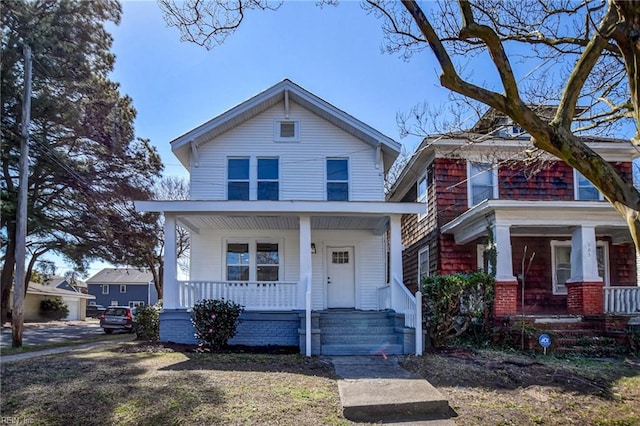 american foursquare style home featuring covered porch