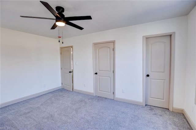 unfurnished bedroom featuring carpet flooring, ceiling fan, and baseboards