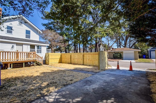 view of yard with fence and a garage