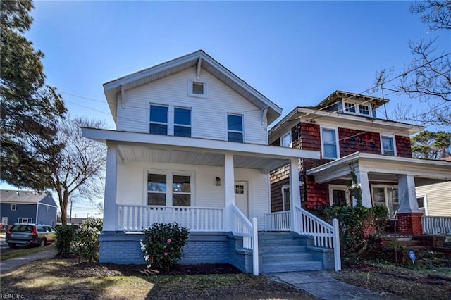 american foursquare style home featuring covered porch