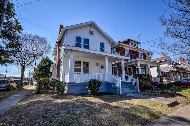 traditional style home featuring covered porch and a chimney