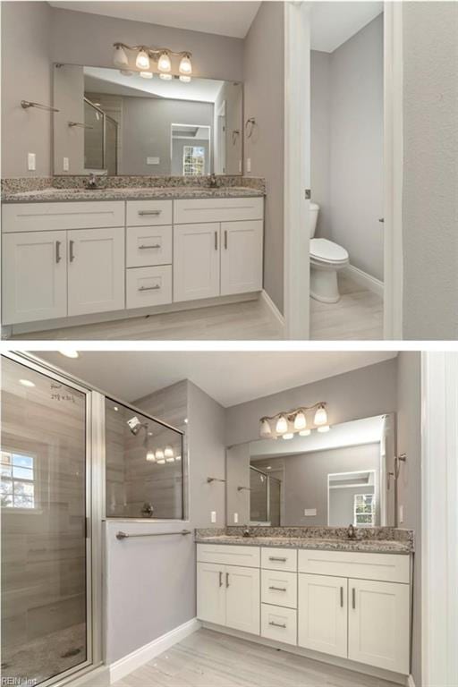 bathroom featuring double vanity, baseboards, toilet, and a shower stall