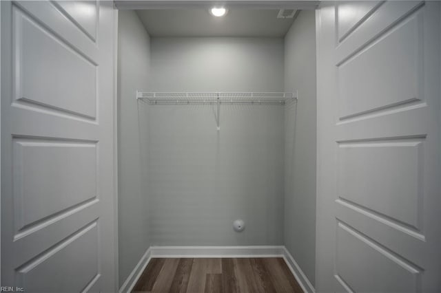 spacious closet with dark wood finished floors