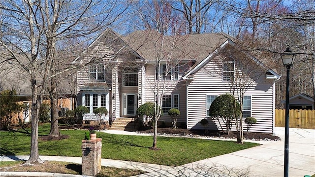 view of front of property with a front yard and fence