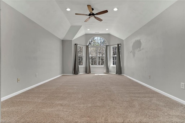 carpeted spare room with vaulted ceiling, recessed lighting, a ceiling fan, and baseboards