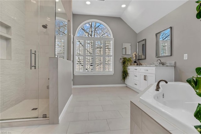 bathroom with lofted ceiling, a tub, a shower stall, baseboards, and vanity